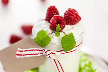 Image showing Raspberries and yoghurt or clotted cream