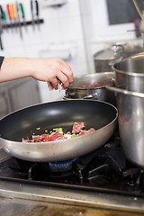 Image showing Chef or braising meat in a frying pan