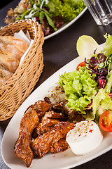 Image showing grilled beef stripes fresh salad and goat cheese