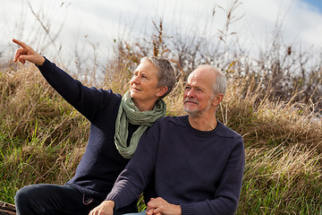 Image showing happy senior couple relaxing together in the sunshine