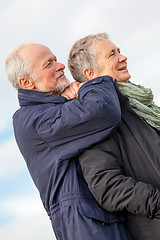 Image showing happy elderly senior couple walking on beach