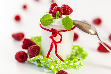 Image showing Raspberries and yoghurt or clotted cream