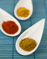 Image showing Dried ground spices in ceramic spoons