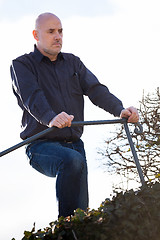 Image showing Thoughtful man sitting on a flight of steps