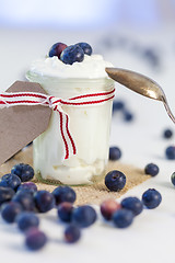 Image showing Jar of clotted cream or yogurt with blueberries