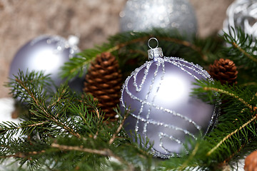 Image showing Silver Christmas ornaments in leaves