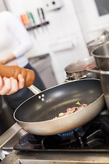 Image showing Chef or braising meat in a frying pan