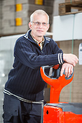 Image showing Posing with a pallet truck