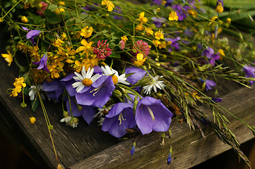 Image showing Bouquet of wildflowers on wooden boards