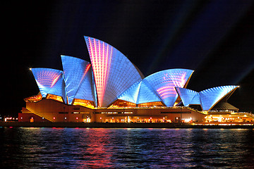 Image showing Sydney Opera Hosue illuminated in blue and red motion strips