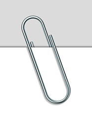 Image showing Metal paperclip and paper