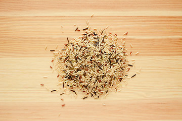 Image showing Wild rice, brown basmati and red camargue grains on wood