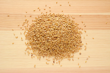 Image showing Golden linseed on wood