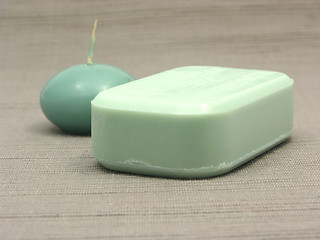 Image showing Green soap and green candle on a  gray background