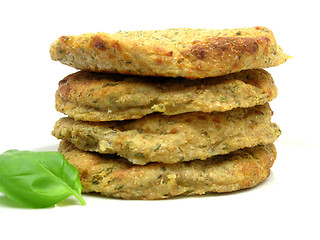 Image showing potato dough cakes with basil lying upon another