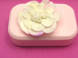 Image showing Pink soap with decoration articles on a  pink background