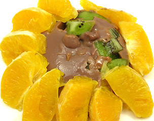 Image showing Chocolate pudding with kiwi fruit and orange