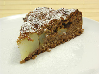 Image showing One slice of pear cake on a white plate dusted with powder sugar