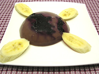 Image showing Chocolate pudding with blueberries, banana and pieces of almonds