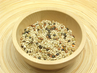 Image showing Wooden bowl with rice and lens mixture on bamboo plate