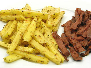 Image showing Soy Geschnetzeltes and french fries on white plate