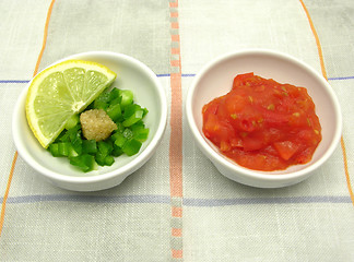 Image showing Little bowls of chinaware with tomatodip and green pepperdip