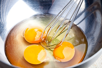 Image showing whisking eggs in metal bowl 