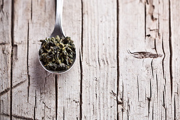 Image showing spoon with dried green tea leaves 