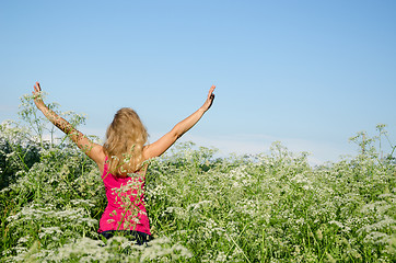 Image showing young woman back view wild caraway meadow summer 