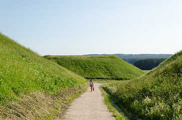 Image showing tourist girl walk mound hills in Kernave 