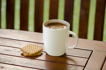 Image showing Cup of hot coffee in white cup and cookie biscuit 