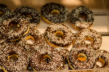 Image showing delicious donut with chocolate icing and sprinkles 