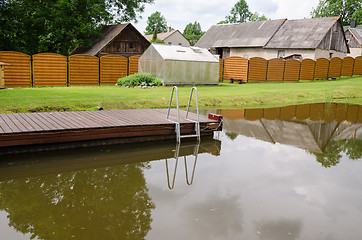 Image showing garden pond with floating footbridge  