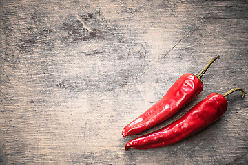 Image showing Red Peppers On Old Wooden Table