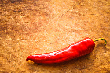 Image showing Red Peppers On Old Wooden Table