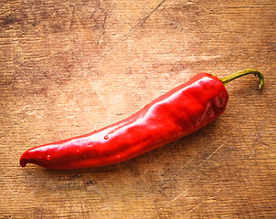 Image showing Red Peppers On Old Wooden Table