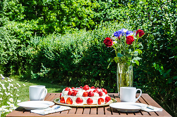 Image showing Made summer table in garden