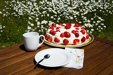 Image showing Made table with strawberry cake and coffee cup