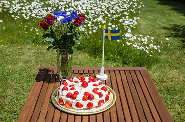 Image showing Table with strawberry cake and decorations