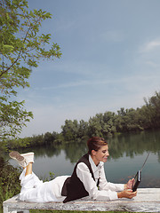 Image showing a woman with laptop in park okj