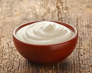 Image showing cream in a brown ceramic bowl