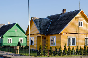 Image showing rural green yellow painted houses along street 