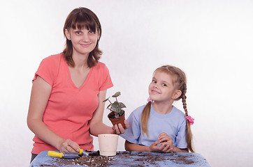 Image showing Mom and daughter transplanted flower room