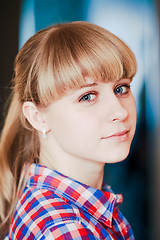 Image showing Close up portrait of a smiling young woman looking at camera