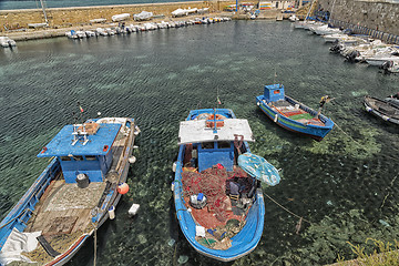 Image showing Fisherman repairs his net on boat