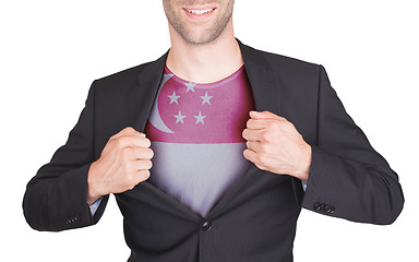 Image showing Businessman opening suit to reveal shirt with flag