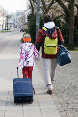 Image showing brother and sister with suitcases