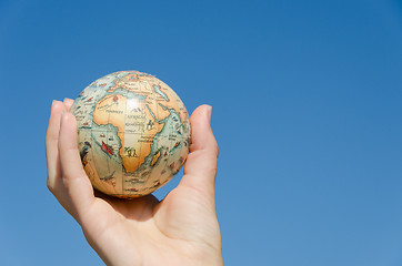 Image showing earth globe model palm on blue background, Africa. 