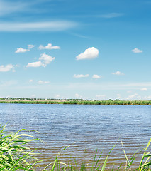Image showing river with green coast and clouds in blue sky