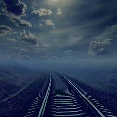 Image showing railroad in night to horizon in fog. moonlight in cloudy sky